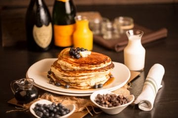 Rustic Root Brunch - Fluffy buttermilk pancakes with blueberries and optional but recommended chocolate chips